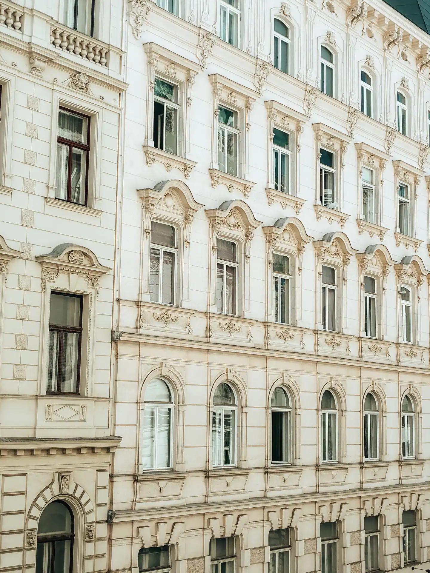 Helle Wiener Fassade mit Stuckfenstern und kleinen Balkonen